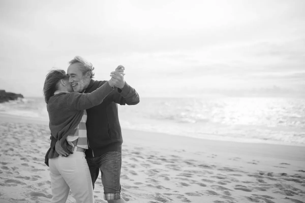 A couple dancing together on the beach